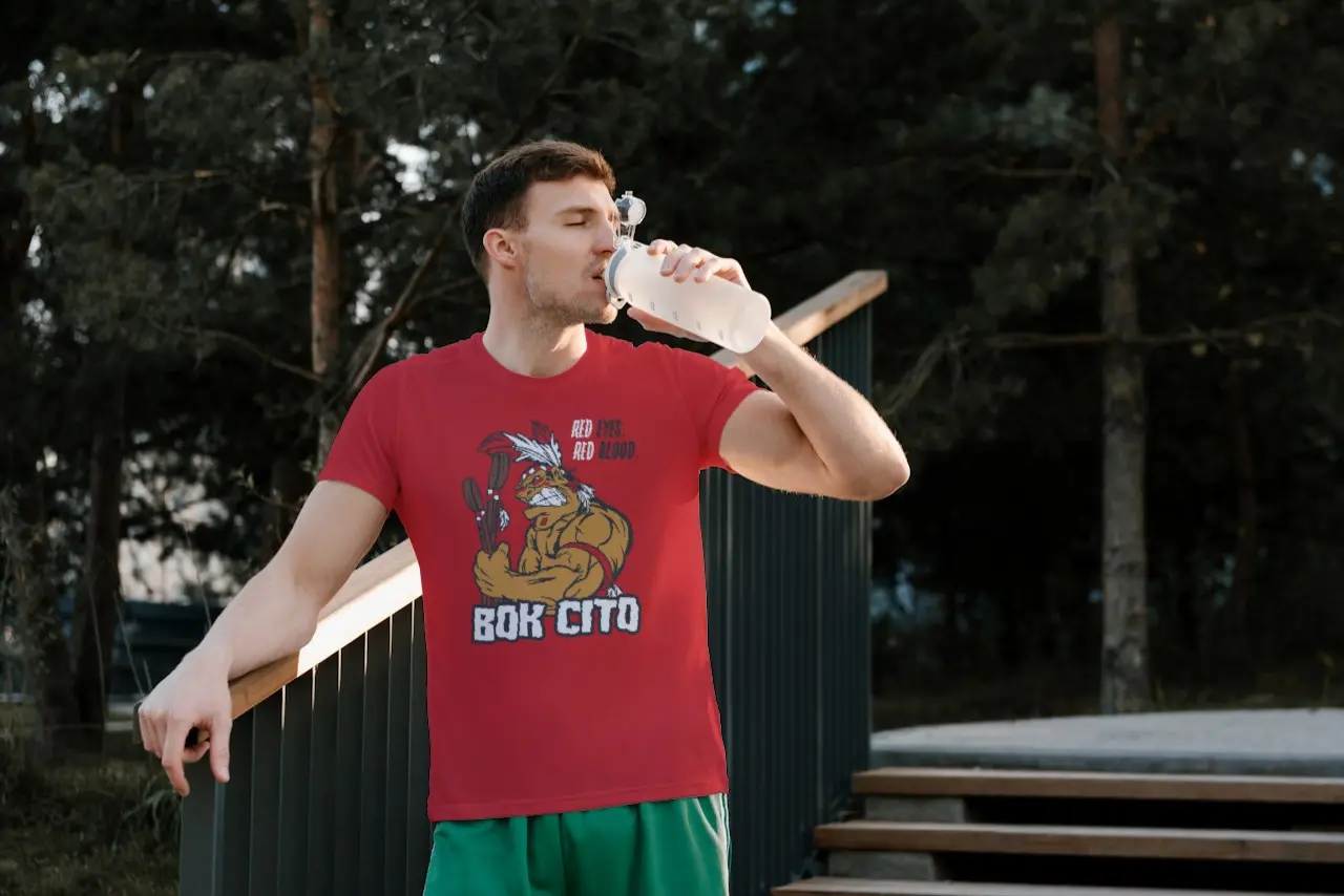 Man drinking a water while wearing a Bok Cito fan shirt